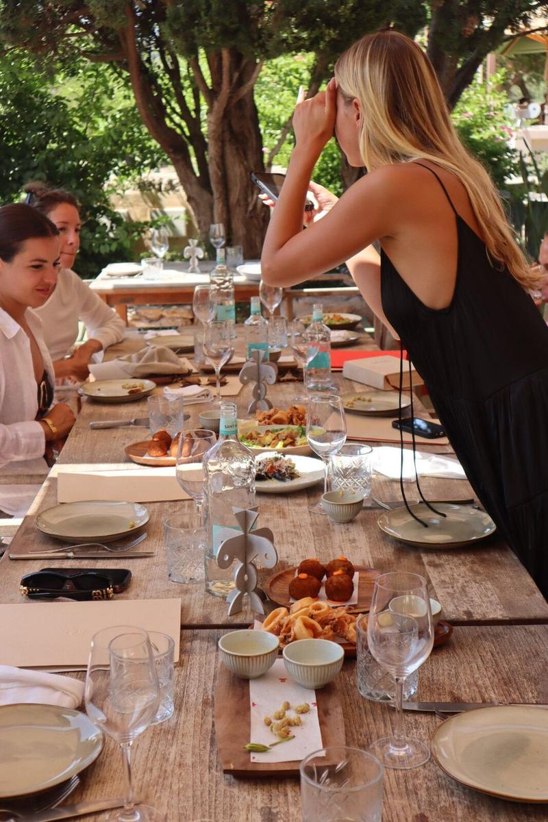 Group sharing tapas at a long wooden table