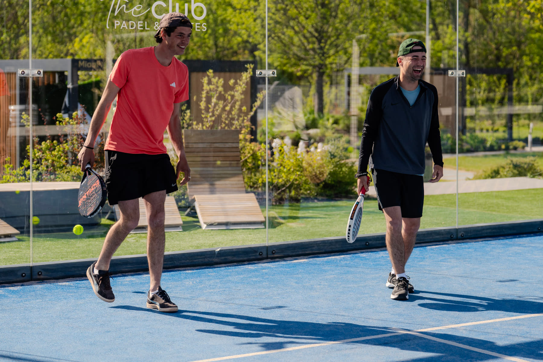 Two players walking off the padel court