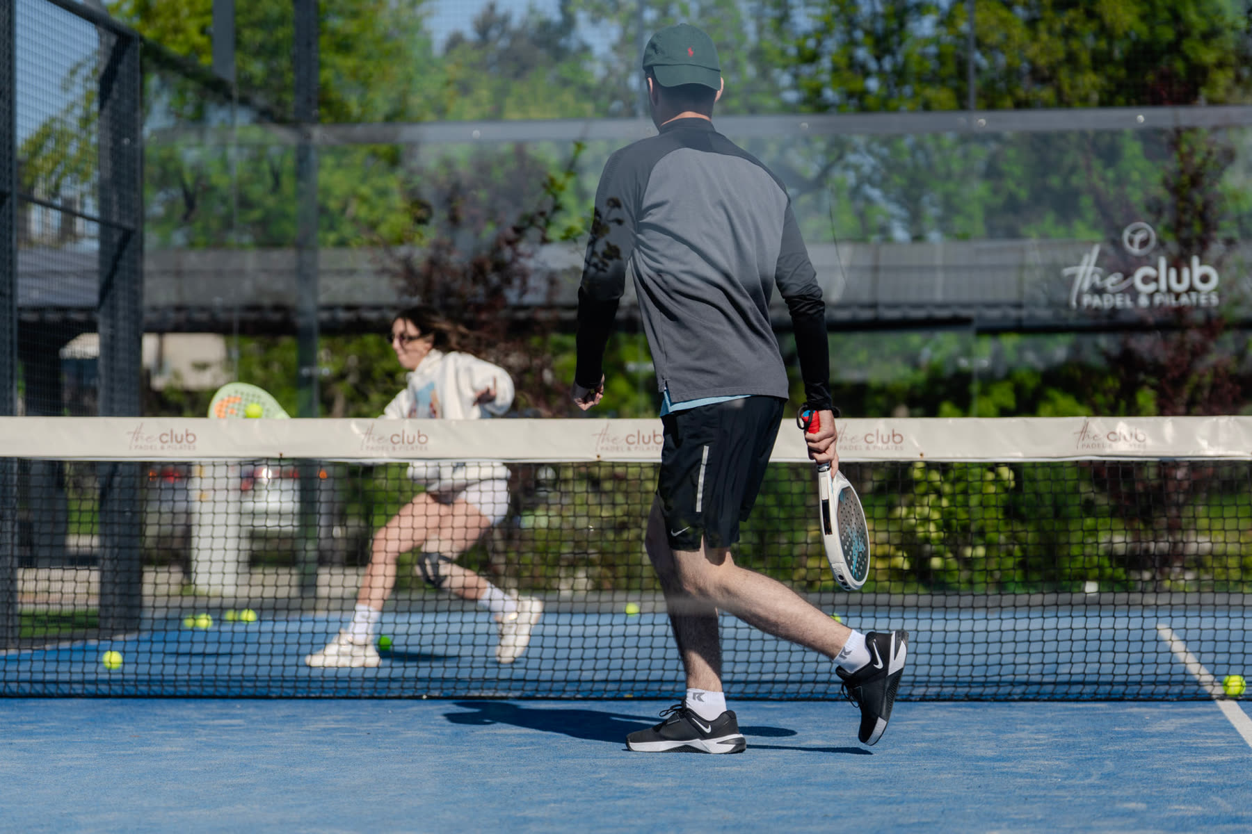 Players rallying across the net during a padel session