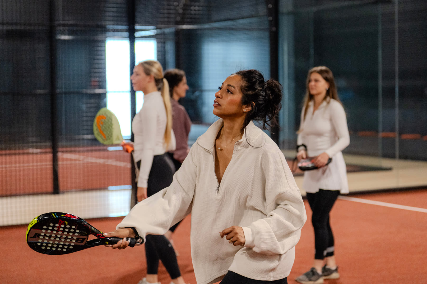 A guest playing padel indoors