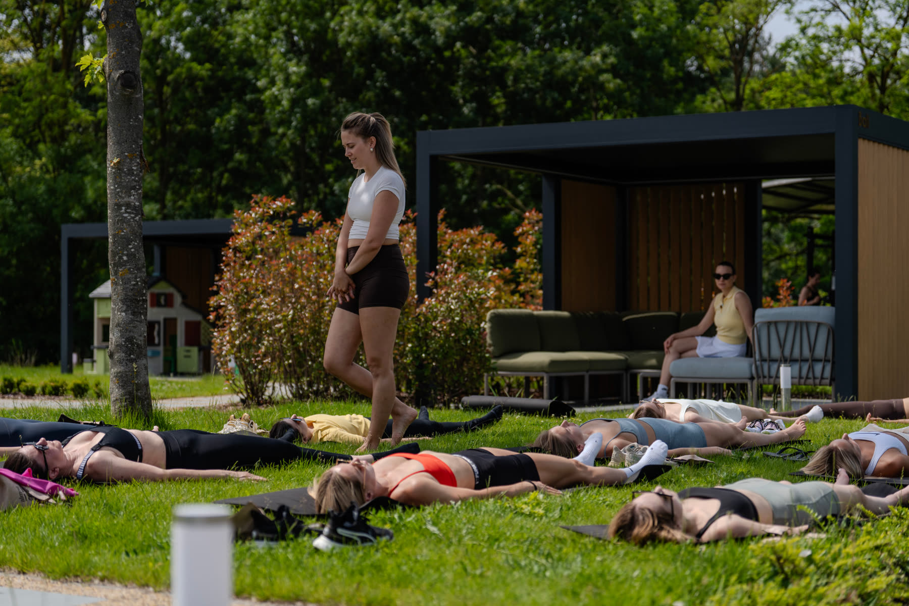 Guests stretching on the lawn at The Club after the padel session
